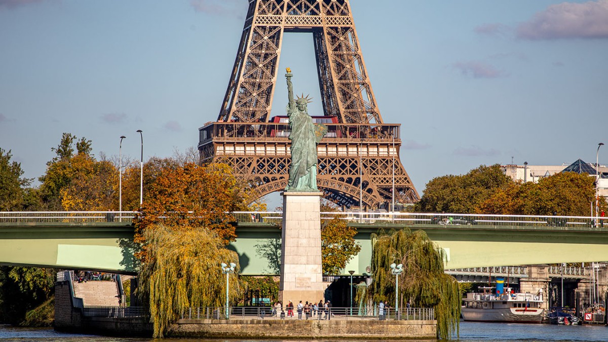 Vista de la Estatua de la Libertad en París y la Torre Eiffel al fondo.
